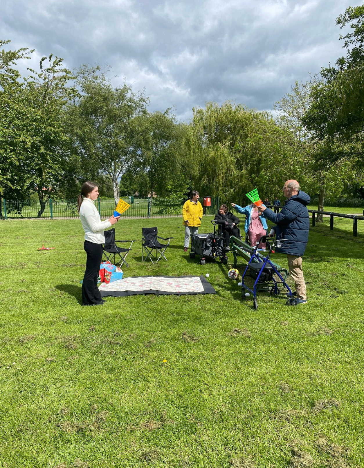 A group playing games together in the park on a communitea meet up