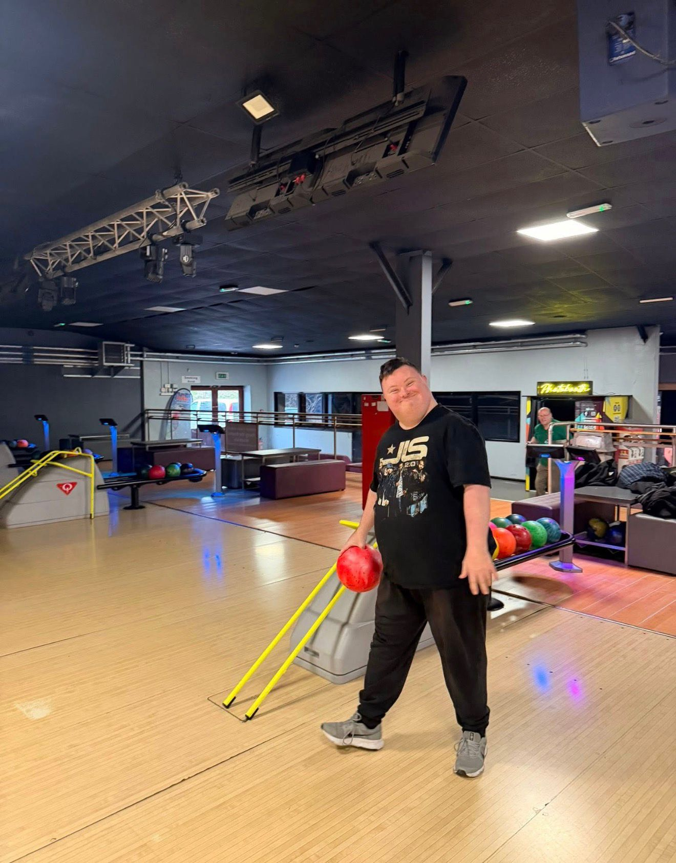 A smiling member enjoying a bowling night out with the group